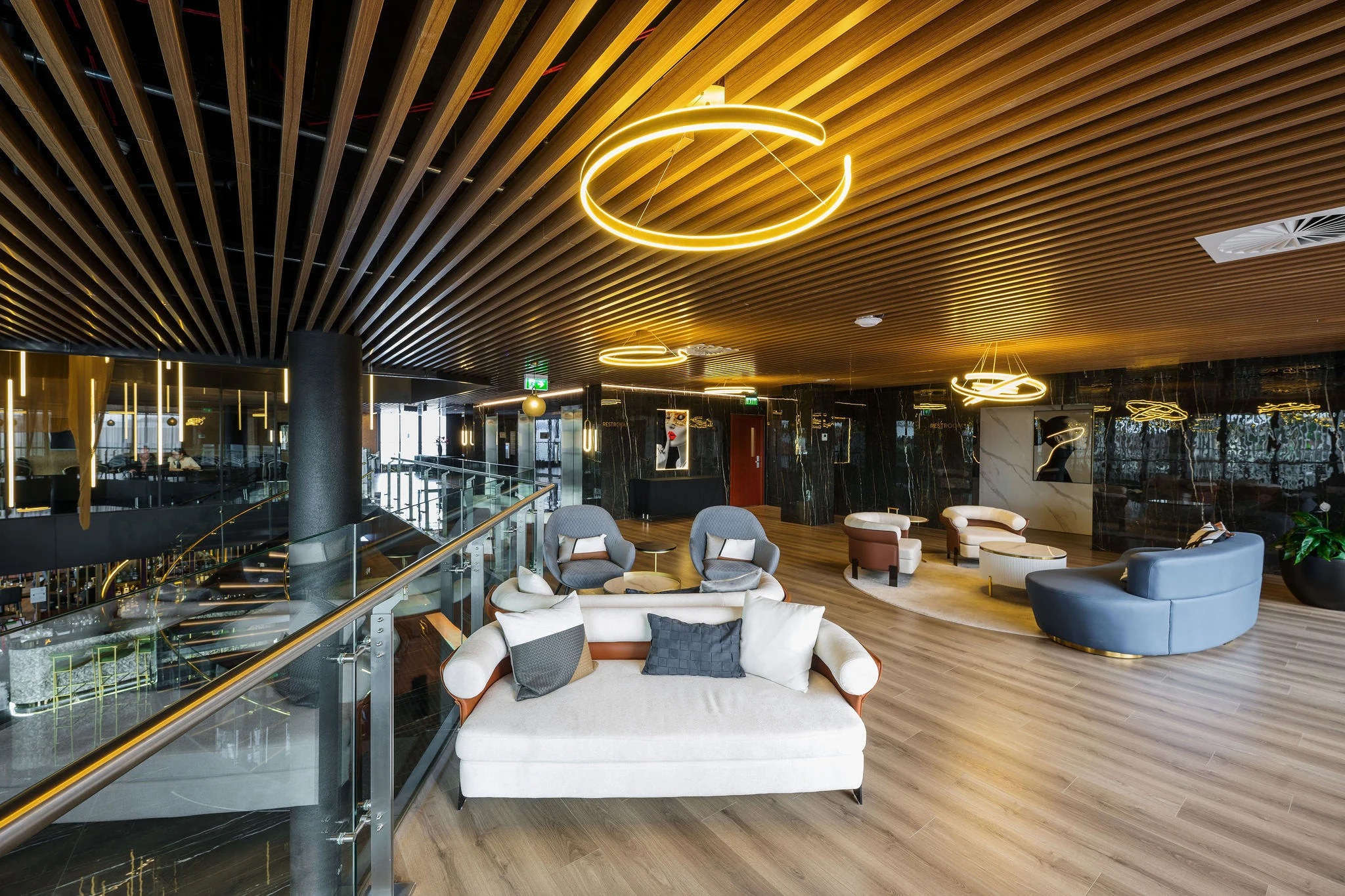 SOHO Hotel Auckland luxury lounge with elegant seating and golden ring pendant lights